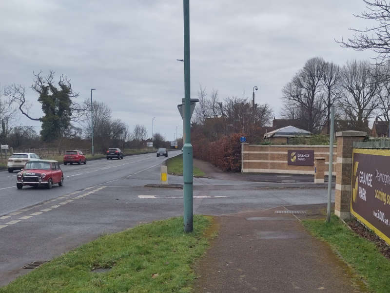 A typical crossing of a busy entrance into a commercial area with no cycle priority, poor path widths, wide and fast entrance and exit mouths off a 40mph carriageway, compounded by poor sighting distances. The Bishops Cleeve LCWIP needs to address existing as well as new routes.